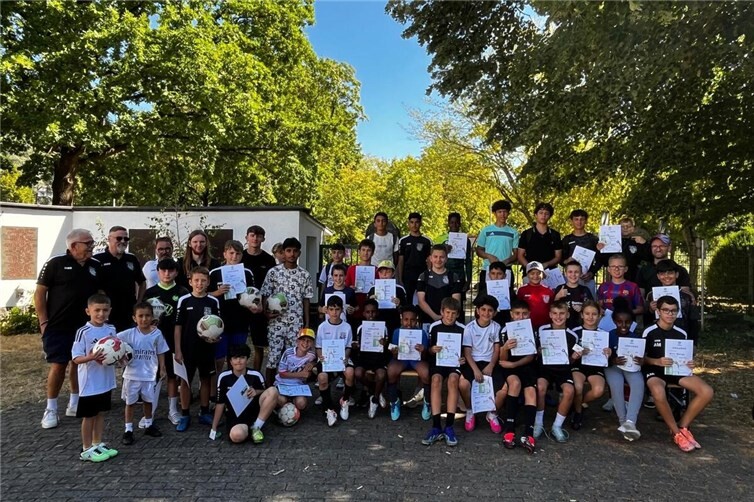 38 Kinder und Jugendliche freuen sich über das DFB-Fußballabzeichen und präsentieren ihre Preise und Urkunden