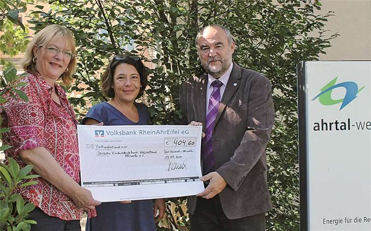 Ahrtal-Werke-Mitarbeiterin Monika Hüllen freut sich, den Scheck über 404 Euro an Ulrike Ring-Scheel und Dittmar Baumung vom Kinderschutzbund überreichen zu können. privat