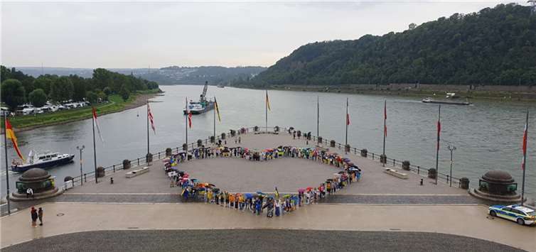 Am Deutschen Eck formenten die 200 Demonstranten ein Herz, um ihren friedlichen Protest gegen Putins Russland nochmals auszudrücken. Foto: Manfred Beuth/Yulia Kaplunovska