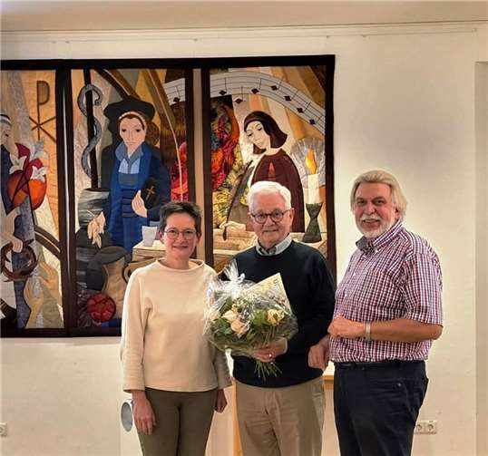Annette Förster und A.-Peter Gillrath dankten Hans-Joachim Schmitz für seinen langjährigen Einsatz für Verein und Weltladen mit Blumen sowie der Ernennung zum Ehrenmitglied.  Foto: Jutta Dietrich/Eine Welt Linz