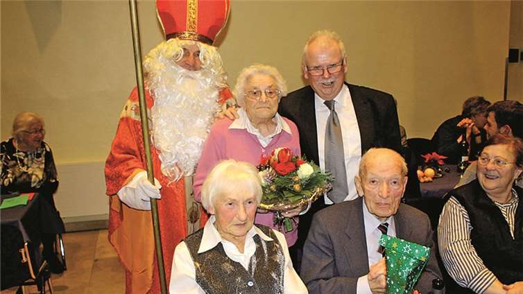 Assistiert vom Nikolaus ehrte Adi Buchwald Gerda Mennert und Wilhelm Ehrenberg als betagteste Gäste der Feier. DL