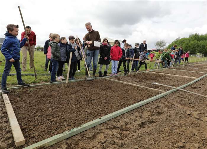Aufmerksam verfolgen die Kinder die Erklärungen zum Einsäen.
