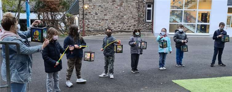 Bei der Feier auf dem Schulhof präsentierten die Schüler sich gegenseitig ihre selbst gebastelten Laternen. Fotos: privat