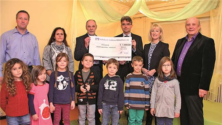 Bei der Scheckübergabe: Alexander Vogt, Vorsitzender des Elternausschusses (v.li.), Leiterin Natalie Skowron, Jürgen Höfer von der Volksbank, den Vorsitzenden des Fördervereins Wolfgang Häring, Bürgermeisterin Marie-Theres Hammes-Rosenstein und Kita-Leiter Dirk Crecelius im Kreise der „Eulenhorst“-Kinder.privat