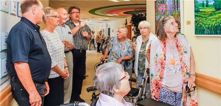 Bei der Vernissage zeigte der Bendofer Künstler Christoph Dames (4. von links) den Bewohnerinnen und Bewohnern seine Gemälde. Mit da-bei Einrichtungsleiter Frank-Ulrich Kron (links) und Schwester Edith-Maria Magar, die Generaloberin der Waldbreitbacher Franziskanerinnen und ehemalige Lehrerin des heutigen Malers (2. von links). Foto: Franziska Sprenger