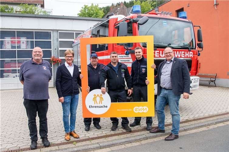 Berthold Nick von der evm übergibt den Spendenbetrag gemeinsam mit Bürgermeister Guido Nisius an die Vertreterinnen und Vertreter der Jugendfeuerwehren.  Foto: Peter Seydel