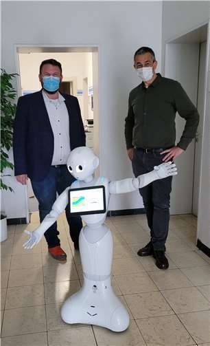 Bürgermeister Christoph Mohr und Büroleiter Thomas Gutfrucht freuen sich über Peppers Einsatz bei der Stadtverwaltung Bendorf.  Fotos: Stadt Bendorf