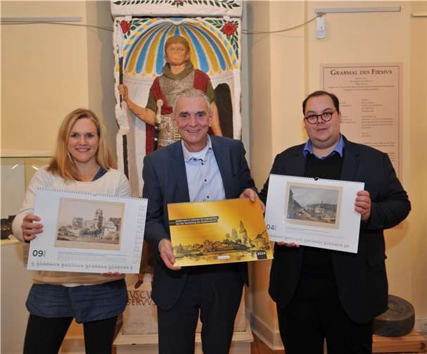 Bürgermeister Claus Peitz (Mitte) sowie Kulturamtsleiterin Charlotte Everling und Museumsleiter Dr. Kai Seebert präsentieren den neuen Wandkalender des Stadtmuseums, der ab jetzt erhältlich ist. Der Kalender zeigt zwölf Druckgraphiken aus dem 18., 19. und frühen 20. Jahrhundert rund um das alte Andernach.  Foto: Stadt Andernach/Maurer
