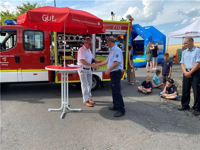 Bürgermeister Karsten Fehr übergibt den Schlüssel für das neue Tragkraftspritzenfahrzeug an Wehrführer Reinhard Schmitz während des traditionellen Sommerfestes der Freiwilligen Feuerwehr Orsberg. Foto: H.-J. Fröhlich Wehrleiter a.D.