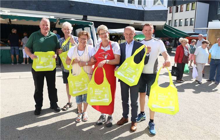 Bunte Taschen für den Markteinkauf in Montabaur– damit gibt die Stadt Montabaur einen Impuls beim nachhaltigen Einkauf. „Gute Idee“, meint Gerlinde Eberth vom Stand der Westerwälder Wurstwaren, „und wir freuen uns natürlich, wenn wir die Taschen mit den Kunden am Donnerstags- und Samstagsmarkt immer wieder sehen.“ (v.l.): Marktmeister Thilo Daubach, Marcel de Lugt, Blumenstand, Ursula Saal, Saal’s Käsekiste, Gerlinde Eberth, Westerwälder Wurstwaren, Josef Schüller, Citymanager Montabaur, Oliver Friedsam, Geflügelstand.Foto: Stadt Montabaur/Olaf Nitz