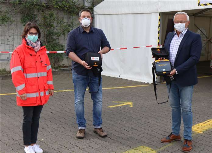 Christian Schneider von der Ludwig-Erhard-Schule (Mitte) übergibt die zwei Defibrillatoren an Landrat Achim Hallerbach und Dr. Corinna Trapp, stellv. Leiterin Gesundheitsamt.Foto: Kreisverwaltung Neuwied