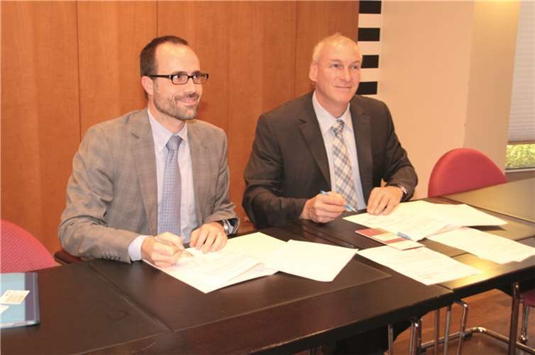 Clemens Hoch, Chef der Staatskanzlei, und Bürgermeister Fred Pretz unterzeichnen die Vereinbarung.