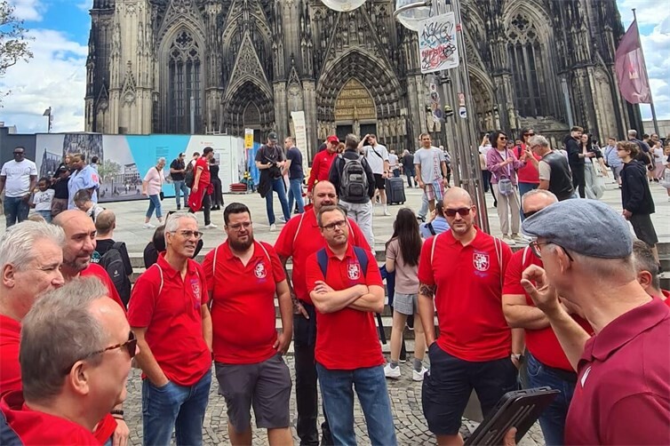 DIe Komitee’ler lauschen gespannt Köbes Guido vor weltbekannter Kulisse.