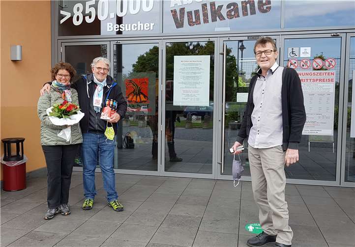 Das erste Besucherpaar wurde vom Lava-Dome Leiter Helmut Koll begrüßt und mit Blumenstrauß und Mendiger Bier beschenkt. Quelle: Stadt Mendig /Lava-Dome Mendig