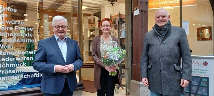 Der Vorsitzende der Linzer Werbegemeinschaft, Didi Pörzgen (rechts), und der Vorsitzende des Vereins Eine-Welt Linz, Hans-Joachim Schmitz, gratulierten der Erstplatzierten im Schaufenster-Wettbewerb der Linzer Werbegemeinschaft, Annette Förster, zu ihrer erfolgreichen Schaufenster-Dekoration.  Foto: privat