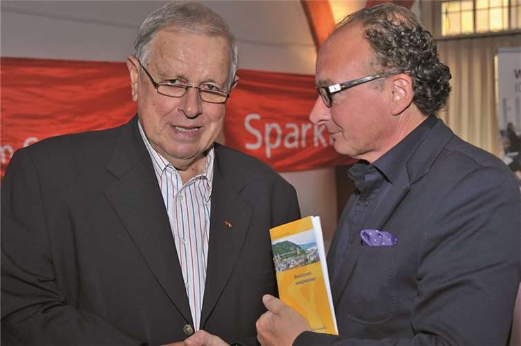 Der Vorsitzende des Seniorenbeirats, Roland Walther, übergibt den ersten neuen Seniorenwegweiser an Oberbürgermeister Achim Hütten (r.).Stadt Andernach/Maurer