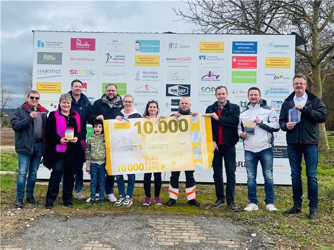 Der Vorstand des Unternehmervereins und die glücklichen Empfänger vor der Werbewand am völlig zerstörten Gelände des TC Bad Bodendorf.  Foto: privat
