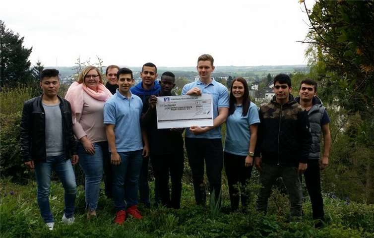 Die Azubis des dritten Lehrjahrs der Volksbank RheinAhrEifel Evanggelos Pechlivanidis (4.v.l.), Christian Schmitz (4.v.r.) und Katrin Näkel (3.v.r.) unterstützten im Rahmen des Azubi-Sozialprojekts eine Woche lang die Arbeit der Lebenshilfe Kreisvereinigung Mayen-Koblenz und übergaben zum Abschluss eine 300-Euro-Spende für die Flüchtlingshilfe des Vereins.  privat