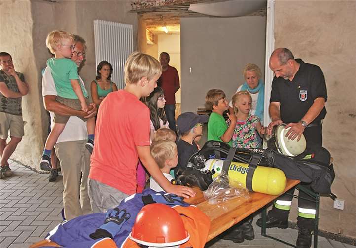 Die Kinder können Ausrüstungsgegenstände vom Helm bis zum Atemschutzgerät genauestens betrachten. Ulrich Schwensfeier