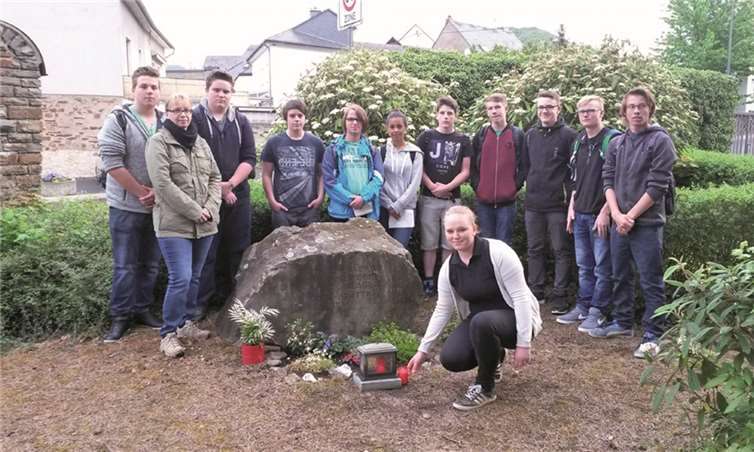 Die Klasse 9a entzündete eine Kerze am Gedenkstein auf dem Treiser Friedhof, ehe sie auf Spurensuche im Ort in Richtung Tunnel ging. TT