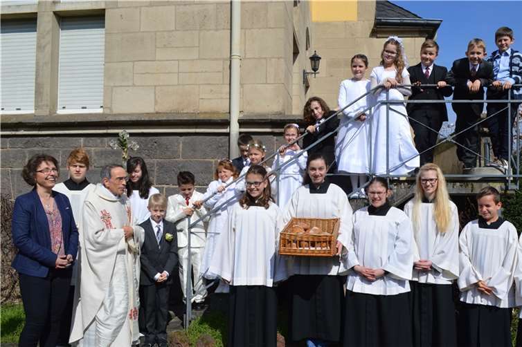 Die Kommunionkinder auf der Treppe mit Pastor Steffens, Gemeindereferentin Anita Schneider und den Messdienern.
