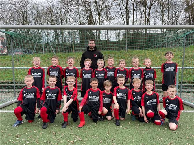 Die Mertlocher F-Jugend mit Michael Thoma und den neuen Trikots.  Foto: privat