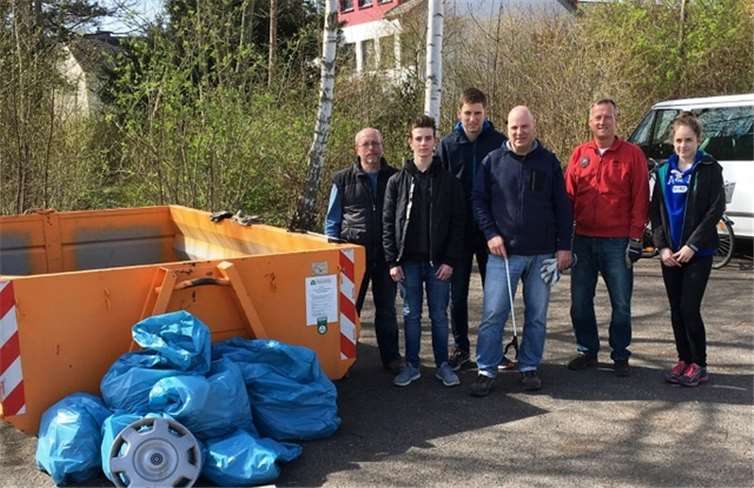 Die Ratsherren Schneider (CDU) und Logemann (FDP) freuen sich gemeinsam mit Anwohnern über die erfolgreiche Müllsammelaktion.privat