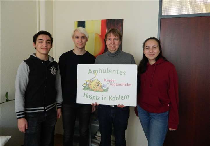 Die Schüler Henning-Jonas Heindl, Maurice Schellenbach und Hanna Höfer bei der Übergabe der Spende an Dirk Griesel vom ambulanten Kinder- und Jugendhospiz.Quelle: Berufliches Gymnasium der Carl Benz Schule Koblenz