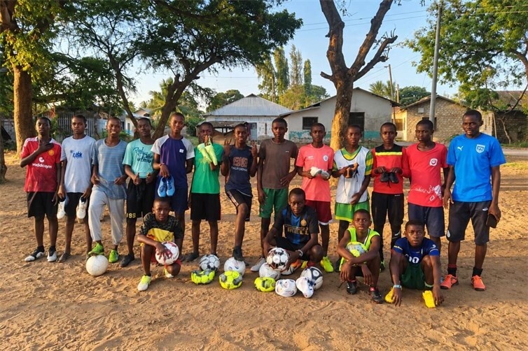 Die Spieler der Simba Soccer Academy tragen stolz ihre neuen Fußballschuhe.