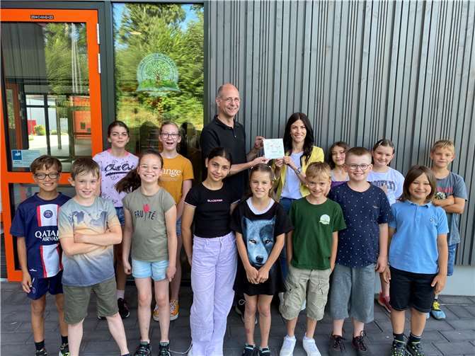 Die Waldschule Montabaur hat die SWR Medientrixx-Plakette für ihr Schulgebäude verliehen bekommen. Gemeinsam freuten sich die Schüler der Klasse 4b mit der Konrektorin Anne Thomi (hinten rechts). Markus Friderichs vom Pädagogischen Landesinstitut (hinten links) überreichte die Plakette. Foto: SWR