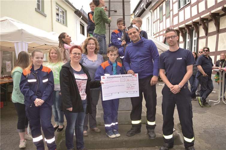 Die Wölle Möhnen übergeben eine Spende an die Jugendfeuerwehr.