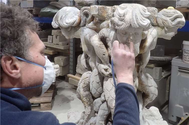 Diplom-Restaurator Victor Kliewe befreit derzeit in Köln die Gruppe der vier fischschwänzigen Figuren, sogenannte Tritonen, von Ablagerungen und Verfärbungen. Foto: Grabowski Restaurierungen