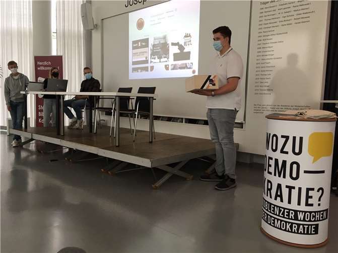 Dominik Schmidt, Vorsitzender der StadtschülerInnenvertretung, stellt seine individuell gestaltete Zeitkapsel vor, verrät jedoch noch nicht alles, was sich darin befindet. Foto: Clara Jung/Stadt Koblenz