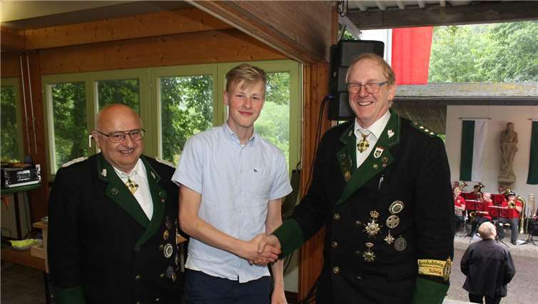 Ehrenmajor Werner Fußhöller und Brudermeister Peter Nonn (rechts) gratulieren dem neuen Schützenprinz Tom Siebold zum Erfolg.