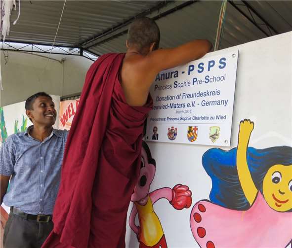 Ein Mönch der benachbarten Manthinda Temple Schule brachte das neue Schild neben dem farbig-fröhlichen Eingang zum Klassenraum der Vorschule an.