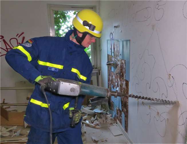 Ein THW-Helfer bohrt Löcher für den Durchbruch. Privat