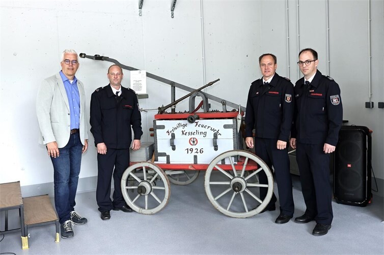 Eine Druckspritze aus dem fühen 19. Jahrhundert, v.li.: VG-Bürgermeister Dominik Gieler, stv. Wehrführer Sascha Bauer, Wehrführer Thorsten Schmitz, Wehrleiter Florian Ulrich