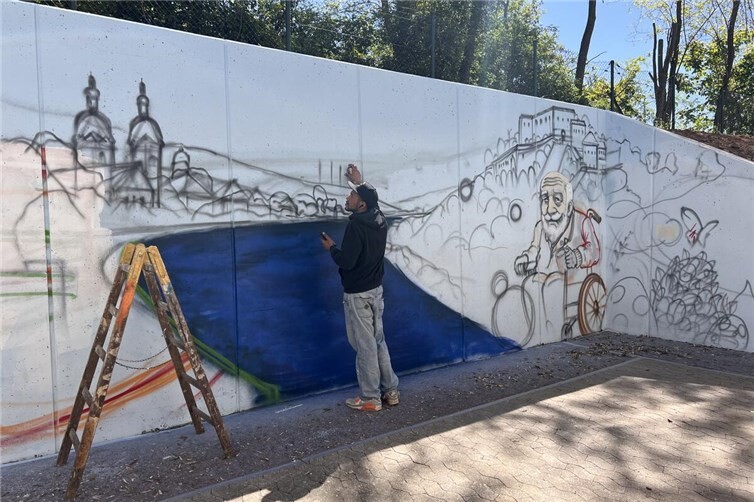 Eine triste Betonmauer wird zum Kunstwerk. Graffitikünstler Arek bei der Gestaltung der Mauer am Seniorenzentrum Bodelschwingh.