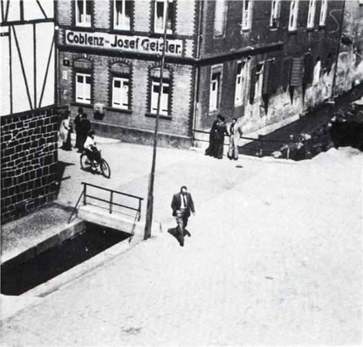 Einst verlief der Bach offen durch die Ortslage von Mülheim-Kärlich. Die historische Aufnahme zeigt den Bereich am heutigen Brauhaus.