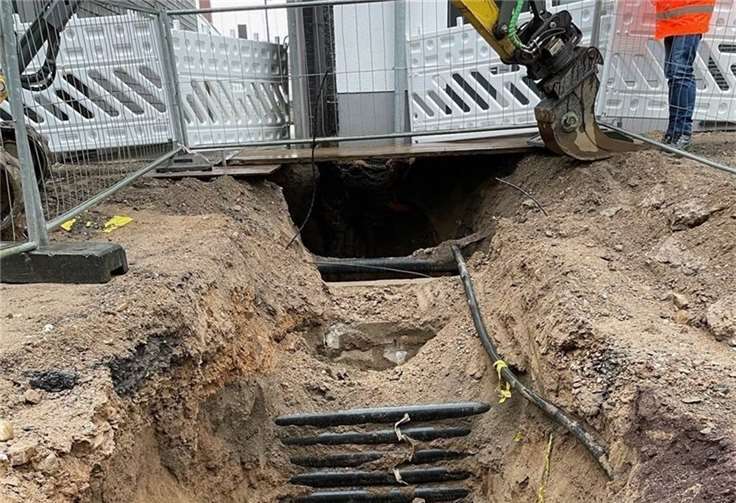 Eng ist es in der Schloßstraße und die Arbeiter müssen für die Erneuerung der Kanalhausanschlüsse baggern, um einen Verbau stellen zu können. Dann aber ist viel Handarbeit mit Hacke und Schaufel nötig, weil Kabelpakete die Gräben queren.  Foto: Peter Dunkel/SWN