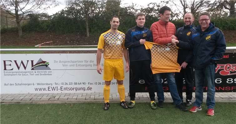 Eric Wimmershoff (Mitte) bei der Trikotübergabe an den ersten Vorsitzenden des SV Viktoria, Harald Piroth (r). Daniele Tulimiero (l.) ist vom neuen Outfit überzeugt, ebenso Trainer Thomas Castor (2.v.r.).privat