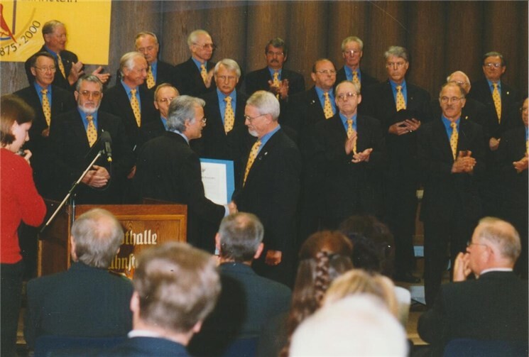 Festakt zur 125-Jahrfeier in der Stadthalle: Präsident Hermann vom Chorverband Rheinland-Pfalz überreicht die Ehrenurkunde dem damaligen Vorsitzenden Günter Sporenberg.Foto: Sammlung Stadtarchiv Lahnstein