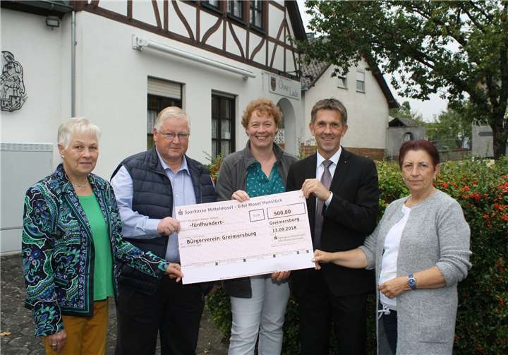 Frank Michels, Regionalleiter der Sparkasse Mittelmosel EMH (2. v. r.), übergibt den Spendenscheck an die Offiziellen des Bürgervereins. TE