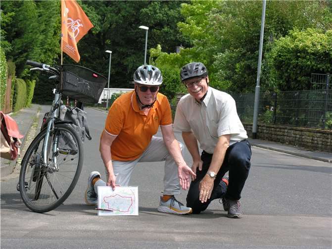 Fritz Spiering und Dr. Georg Wilmers zeigen im Uhlandweg die Stelle, an der der querlaufende Bordstein entfernt wurde und die Stelle nun stoßfrei mit dem Rad befahren werden kann. Foto: ADFC