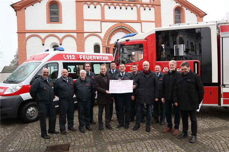 Gemeinsam überreichen Pastor Frank Werner, Hans Seul und Kurt Heuser (v.r.n.l.) den symbolischen Spendenscheck an Stadtwehrleiter Andreas Braun, Vertreter der Löschgruppen aus dem Stadtgebiet und Bürgermeister Andreas Geron.  Foto: Stadtverwaltung Sinzig/Melanie Walkenbach