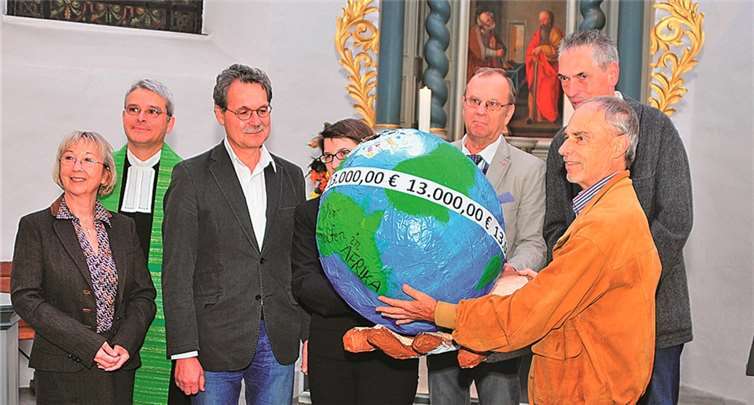 Gero Nölken (Vorsitzender des Presbyteriums), rechts, überreicht Dr. Clemens Wagner (3. von links) gemeinsam mit Mitgliedern des Presbyteriums die „Weltkugelspardose“ mit dem Spendenbetrag von 13.000 Euro. Walter Rohwedder