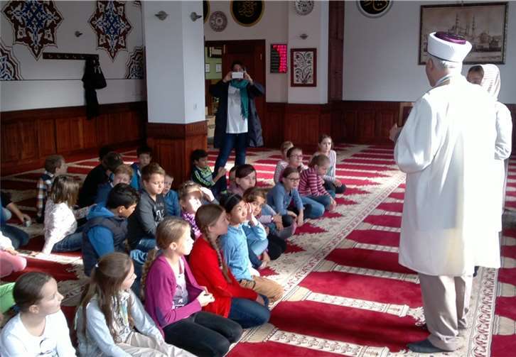 Gülistan Serbest mit dem Hodscha erläutern den Kindern der Bodelschwingh-Grundschule den Gebetsraum der Moschee Yeni Cami in Bendorf-Mülhofen. O. Oguz