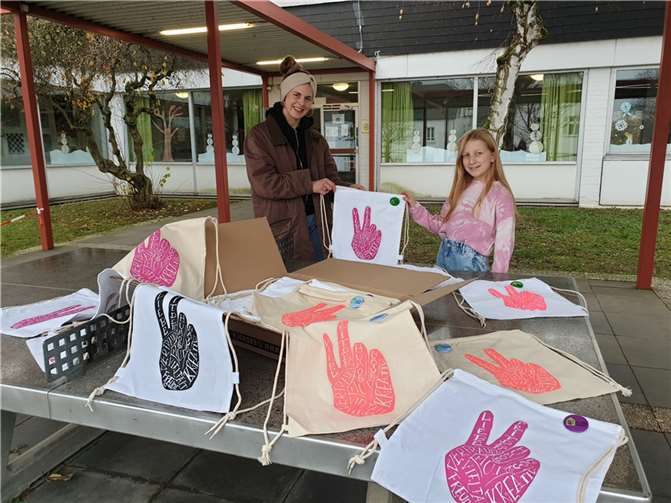 Hannah Wirfs, Jugendfachkraft der Gemeinde Wachtberg überreichte der Schülersprecherin der Schule im Ländchen am Standort Villip die selbst bedruckten und mit Schokolade gefüllten Turnbeutel für alle Mädchen und Jungen der Schule.Foto: privat