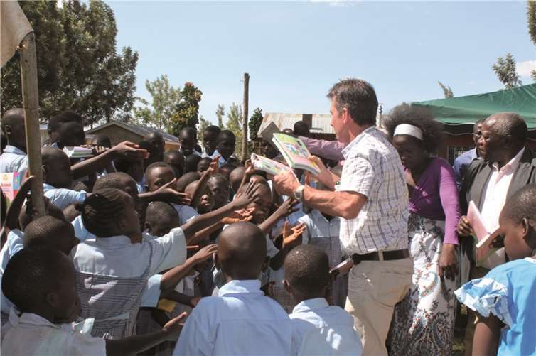Hans-Josef Weiler verteilt neue Schulbücher, die von „Malaika“ beschafft wurden. „Malaika-Sonne für Afrika e.V.“