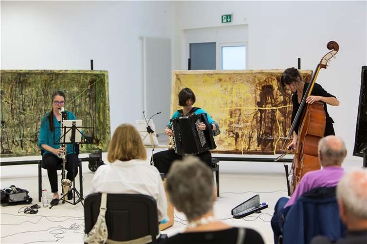 Heather Roche, Eva Zöllner und Nina de Heney (v.l.n.r.) schaffen nordische Klanglandschaften. Im Hintergrund Arbeiten der norwegischen Künstlerin Marit Tingleff.Foto: Raphaël Languillat